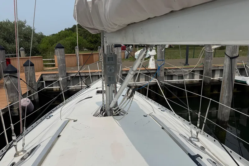 Slide: The Image of 1989 Beneteau First 41s5 sailboat docked, showing deck and rigging details. - 8