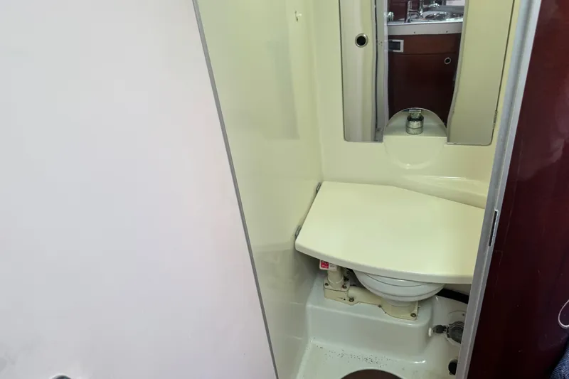 Slide: The Image of 1989 Beneteau First 41s5 yacht bathroom with compact toilet and mirror. - 30