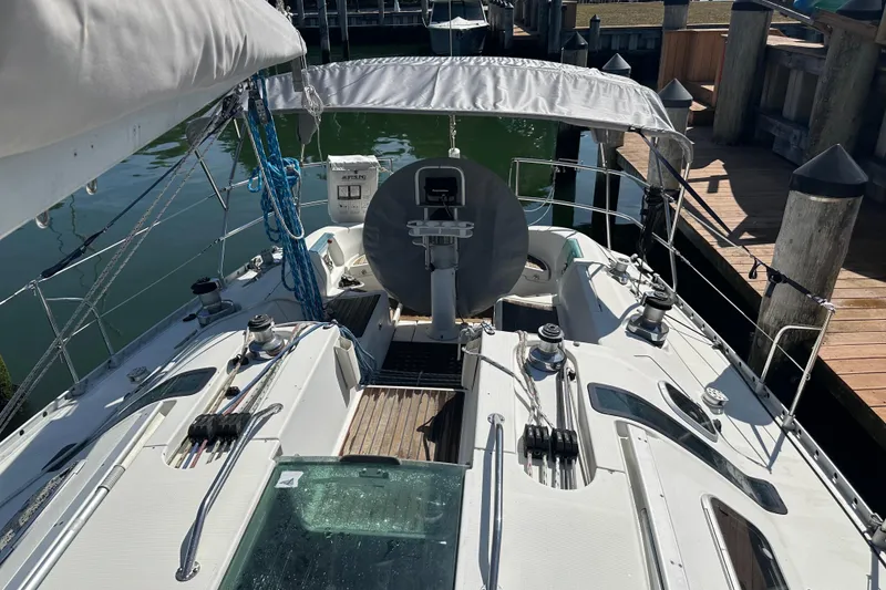 Slide: The Image of 1989 Beneteau First 41s5 sailboat docked, showcasing cockpit and deck details. - 12