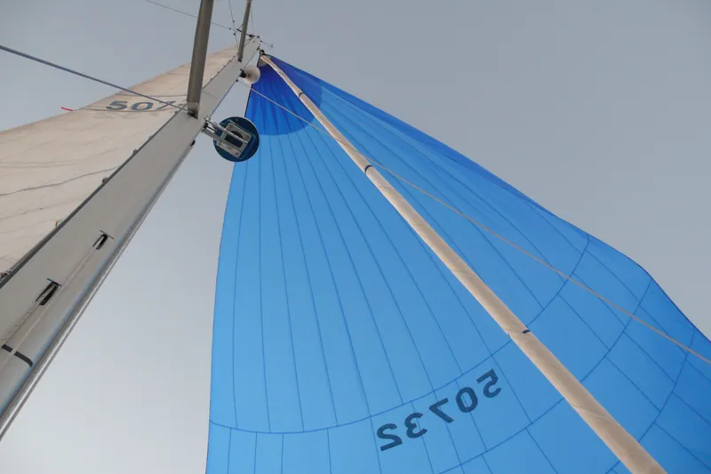 Slide: The Image of Sailboat mast and blue sail of 1989 Beneteau First 41S5 against clear sky. - 36