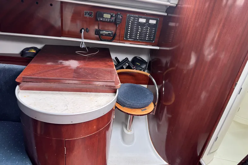 Slide: The Image of Interior of 1989 Beneteau First 41s5 yacht with navigation equipment and wooden furnishings. - 25