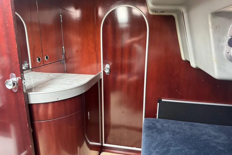 Slide: The Image of Interior of 1989 Beneteau First 41s5 yacht with wooden cabinetry and curved door. - 24