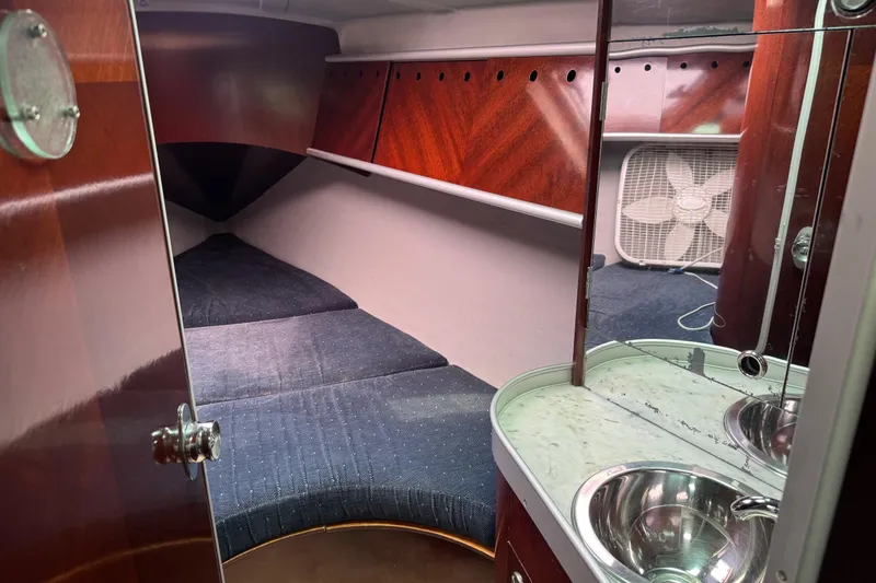 Slide: The Image of Interior cabin of 1989 Beneteau First 41s5 sailboat with wood finish and compact sink. - 31