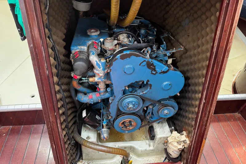 Slide: The Image of Engine compartment of a 1989 Beneteau First 41s5 sailboat, featuring a blue marine engine. - 32