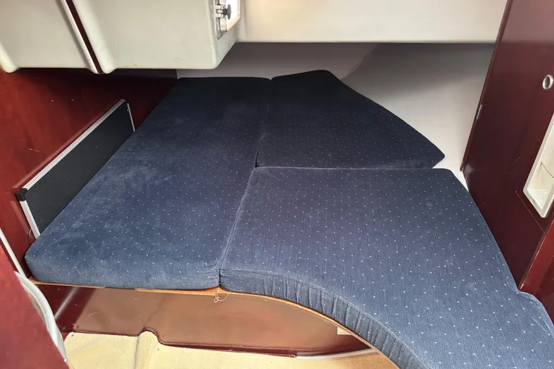 Slide: The Image of Interior cabin of 1989 Beneteau First 41s5 sailboat with blue cushioned seating. - 27
