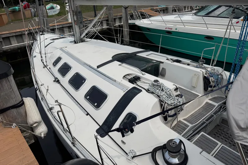 Slide: The Image of 1989 Beneteau First 41s5 sailboat docked, showcasing deck and rigging details. - 10