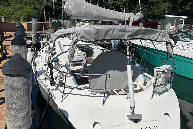 Slide: The Image of 1989 Beneteau First 41s5 sailboat docked at marina, covered sails, sunny day. - 13
