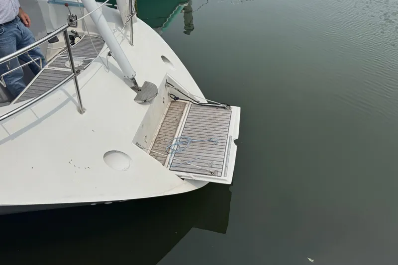 Slide: The Image of Beneteau First 41s5 (1989) yacht stern with swim platform on calm water. - 16