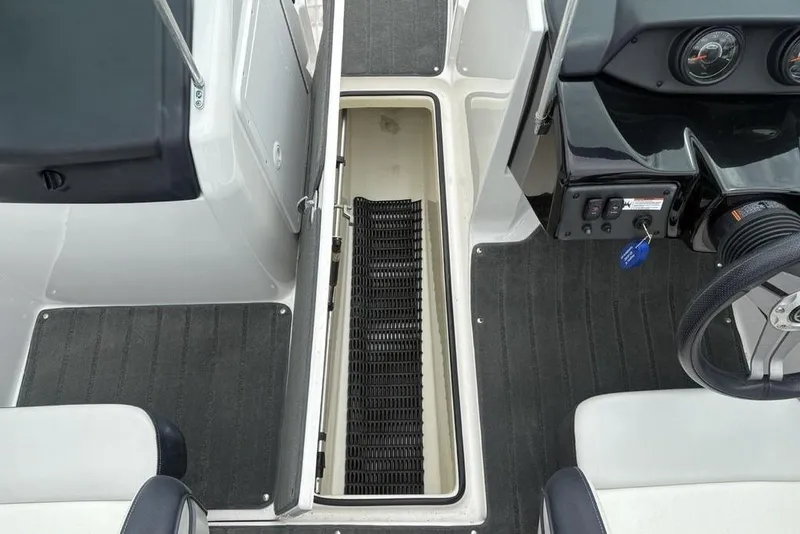 Slide: The Image of 2017 Yamaha Boats SX195 interior with open storage compartment and steering wheel. - 11