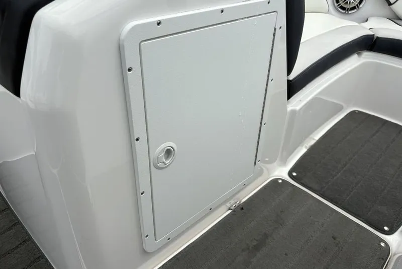 Slide: The Image of 2017 Yamaha Boats SX195 interior storage compartment with gray flooring. - 12