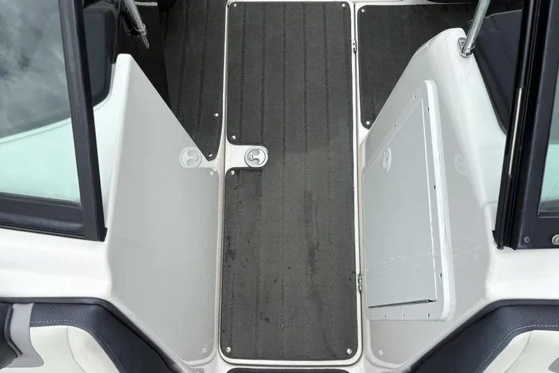Slide: The Image of 2017 Yamaha Boats SX195 interior walkway with black flooring and white panels. - 14