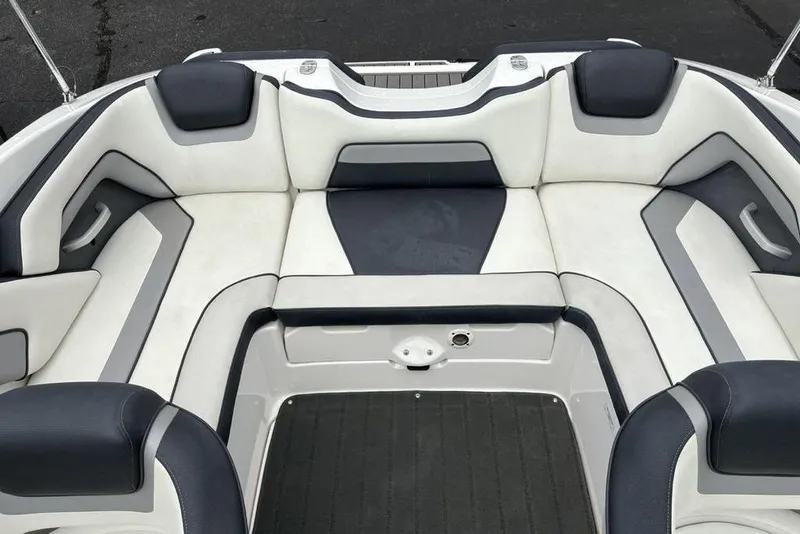 Slide: The Image of 2017 Yamaha Boats SX195 interior seating with white and gray upholstery. - 26