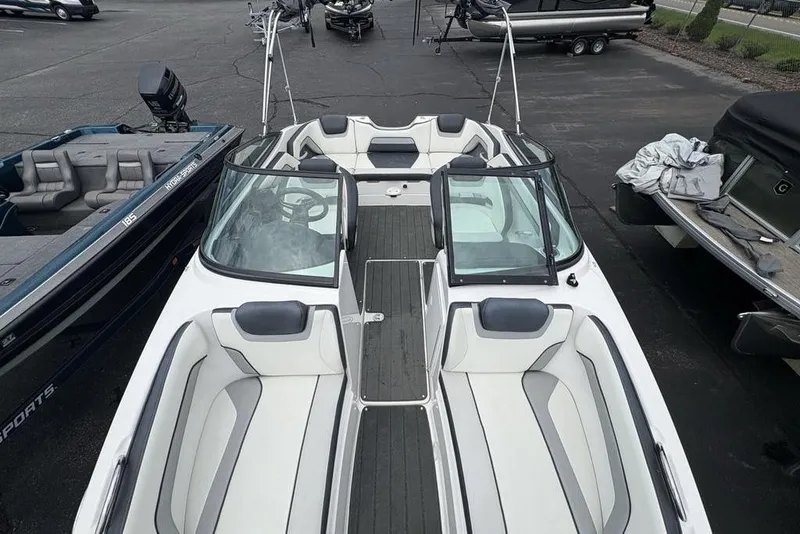 Slide: The Image of 2017 Yamaha Boats SX195, sleek white interior, docked among other boats. - 30