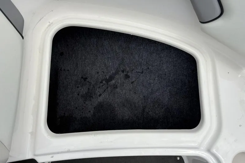 Slide: The Image of Storage compartment in 2017 Yamaha SX195 boat, featuring a dark interior lining. - 8