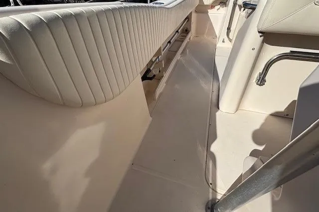 Slide: The Image of Interior view of a 2005 Grady-White Advance 257 boat, featuring white seating and flooring. - 11