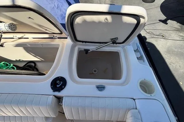 Slide: The Image of 2005 Grady-White Advance 257 boat with open storage compartment, white interior. - 13