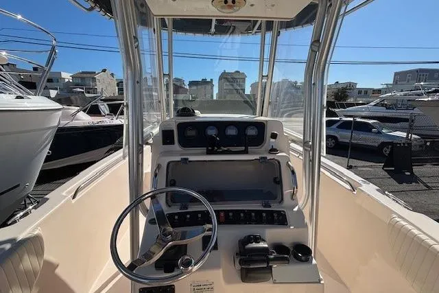 Slide: The Image of 2005 Grady-White Advance 257 boat interior with covered engines and seating area. - 18