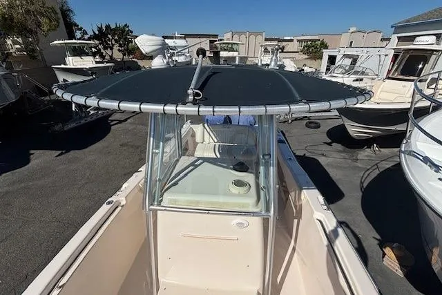 Slide: The Image of 2005 Grady-White Advance 257 boat with T-top and rod holders, docked under clear sky. - 20