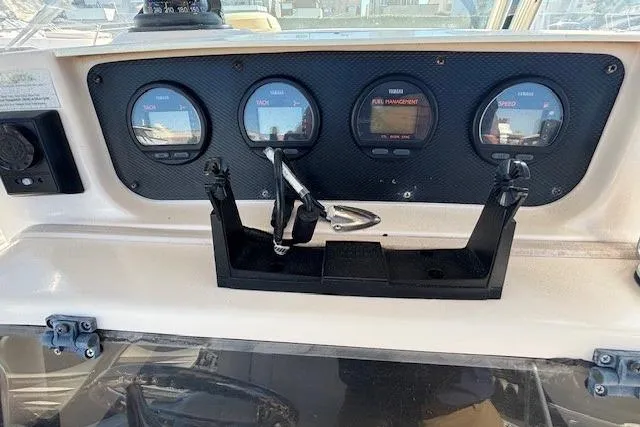 Slide: The Image of 2005 Grady-White Advance 257 boat console with steering wheel and controls. - 22