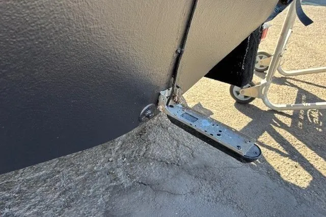 Slide: The Image of 2005 Grady-White Advance 257 boat with covered outboard motors in a marina. - 26