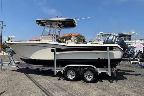 Slide: The Image of 2005 Grady-White Advance 257 boat on trailer, featuring dual outboard engines. - 3