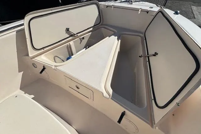 Slide: The Image of 2005 Grady-White Advance 257 boat with open storage compartment. - 6