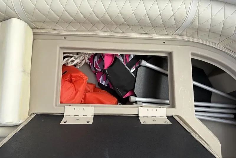 Slide: The Image of Storage compartment in a 2015 Bennington 24 S Series boat with life jackets and equipment. - 15