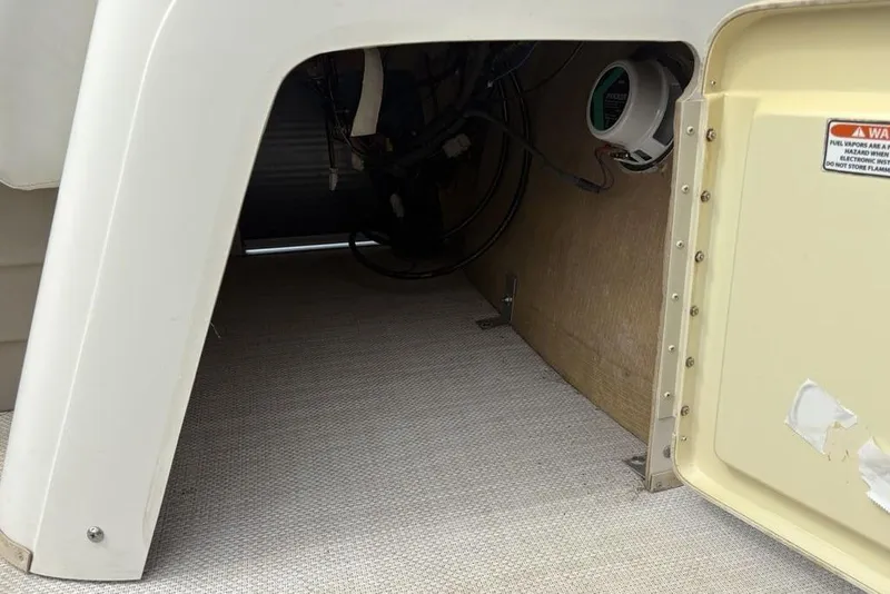 Slide: The Image of Interior view of a 2015 Bennington 24 S Series boat compartment with wiring and speaker. - 16
