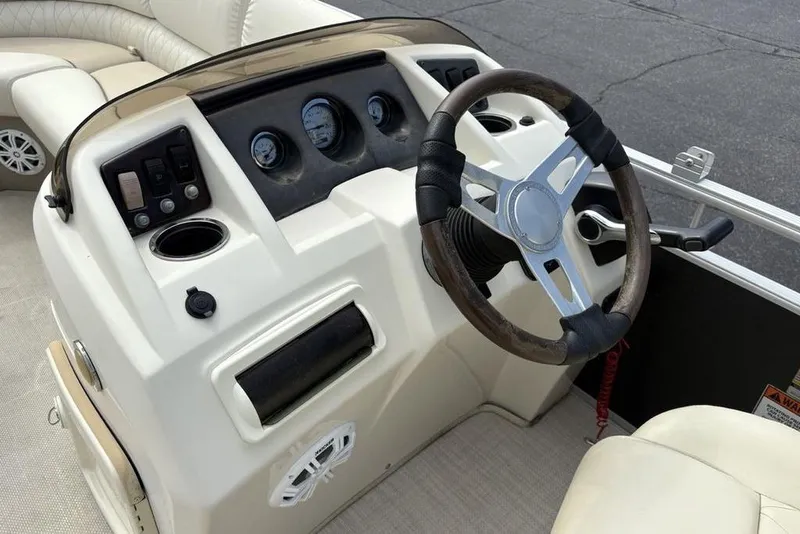 Slide: The Image of Steering console of 2015 Bennington 24 S Series boat with gauges and controls. - 17