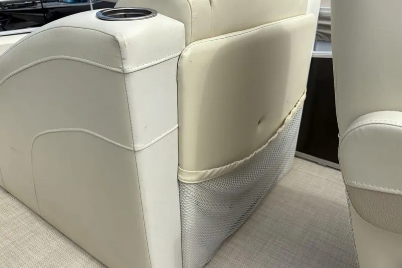 Slide: The Image of 2015 Bennington 24 S Series boat seat with cup holder and storage net. - 18