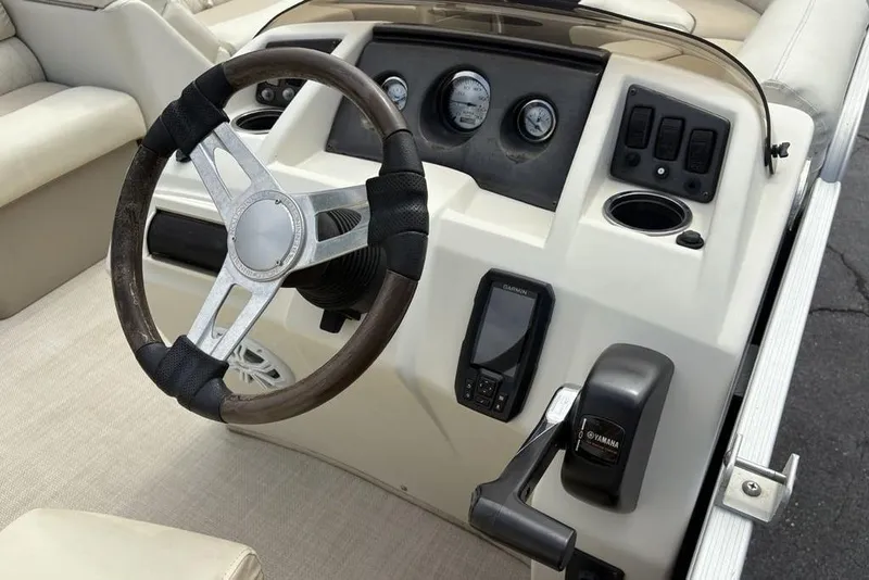 Slide: The Image of Steering console of 2015 Bennington 24 S Series boat with gauges and controls. - 19