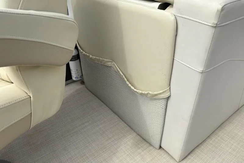 Slide: The Image of 2015 Bennington 24 S Series boat interior with beige seating and storage pocket. - 20