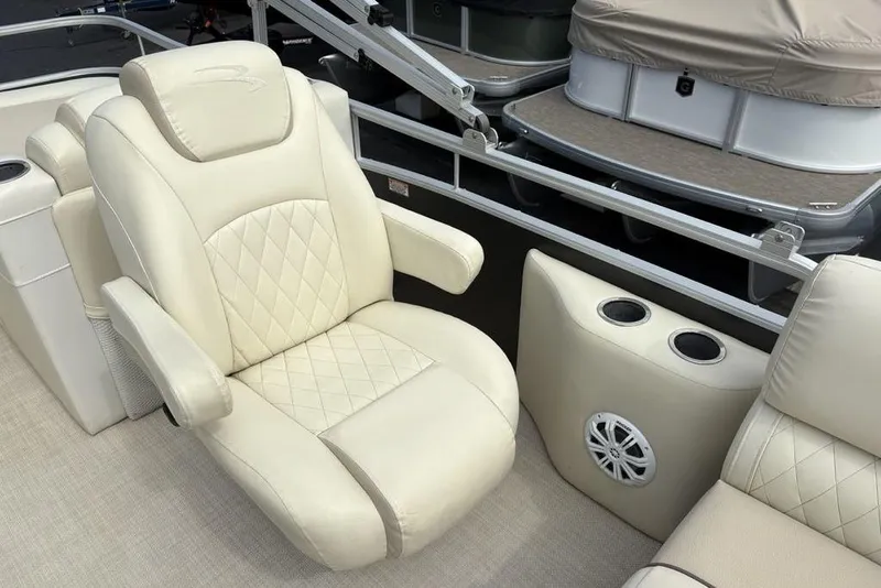 Slide: The Image of Luxurious seating on 2015 Bennington 24 S Series pontoon boat with cup holders and speaker. - 22