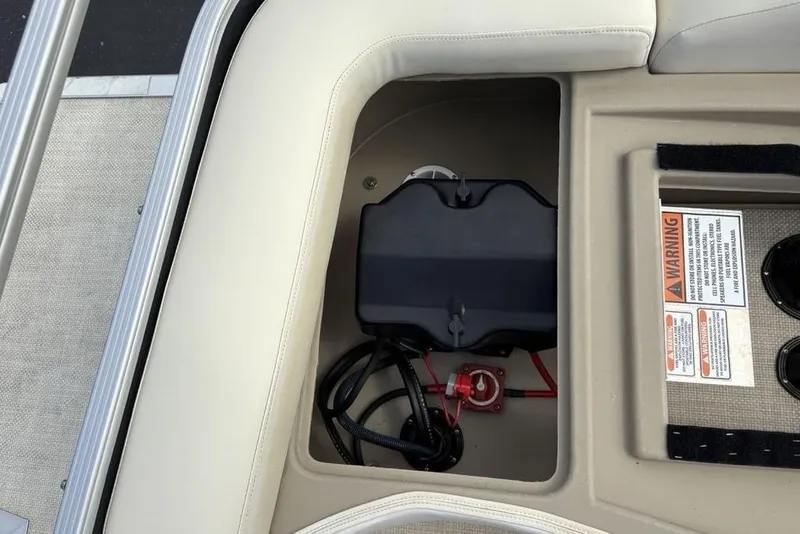 Slide: The Image of Battery compartment of a 2015 Bennington 24 S Series boat with warning labels. - 26