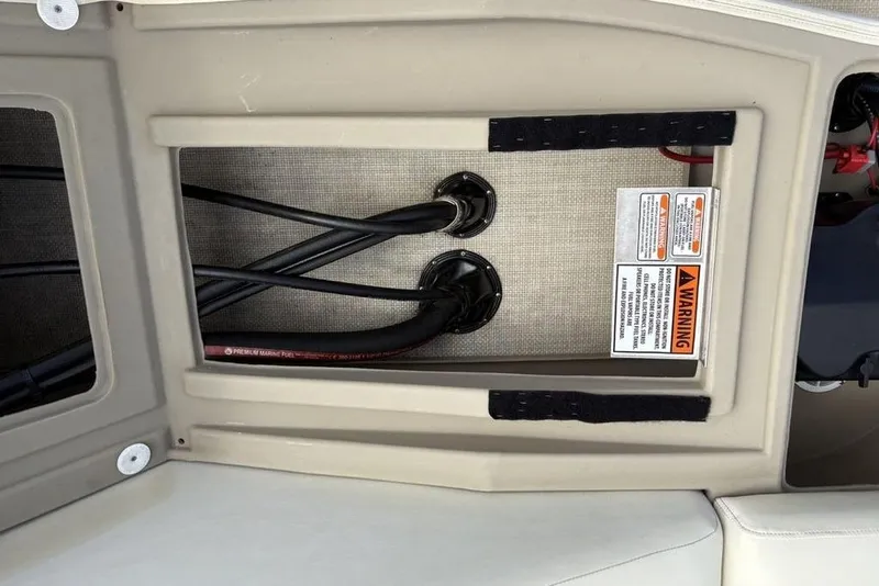 Slide: The Image of 2015 Bennington 24 S Series boat wiring compartment with warning label and cables. - 27
