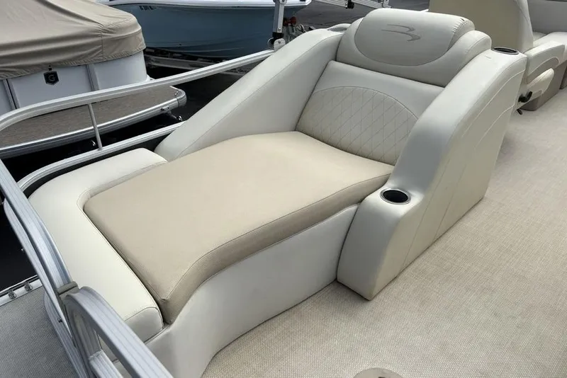 Slide: The Image of Luxurious seating on a 2015 Bennington 24 S Series pontoon boat, featuring cup holders. - 28