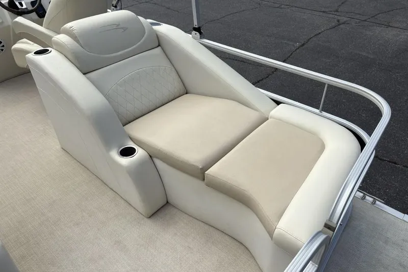 Slide: The Image of 2015 Bennington 24 S Series boat with luxurious beige seating and cup holders. - 29