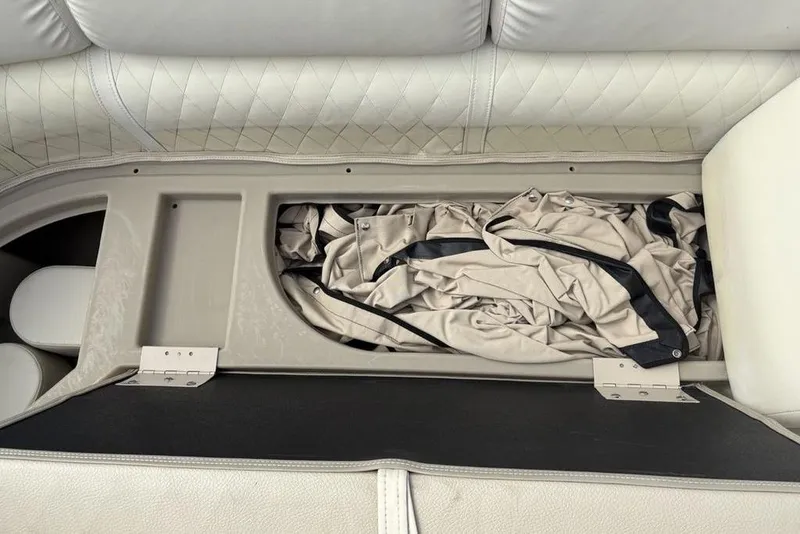 Slide: The Image of Storage compartment in a 2015 Bennington 24 S Series boat with folded cover inside. - 6