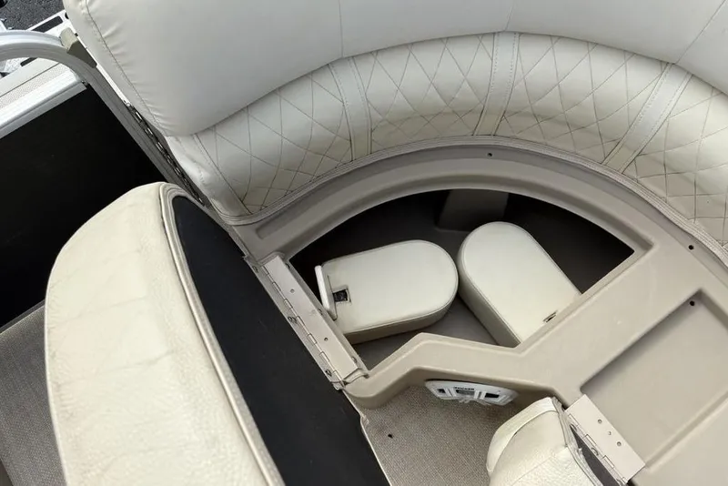 Slide: The Image of 2015 Bennington 24 S Series boat interior with cushioned seating and storage compartments. - 8