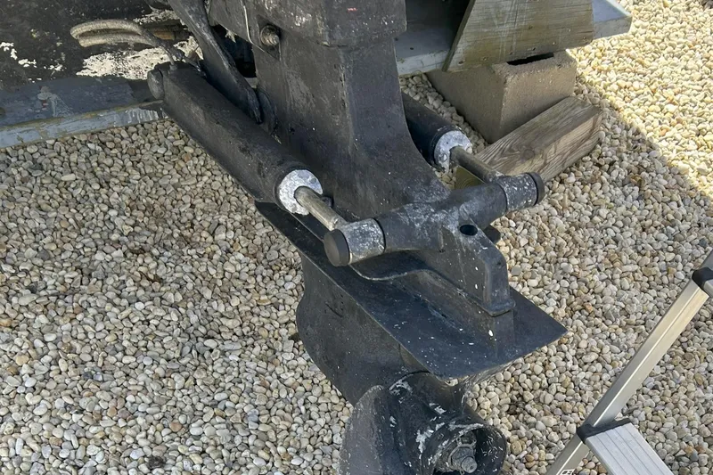 Slide: The Image of 2007 Sea Ray 205 Sport boat engine part on gravel surface. - 12