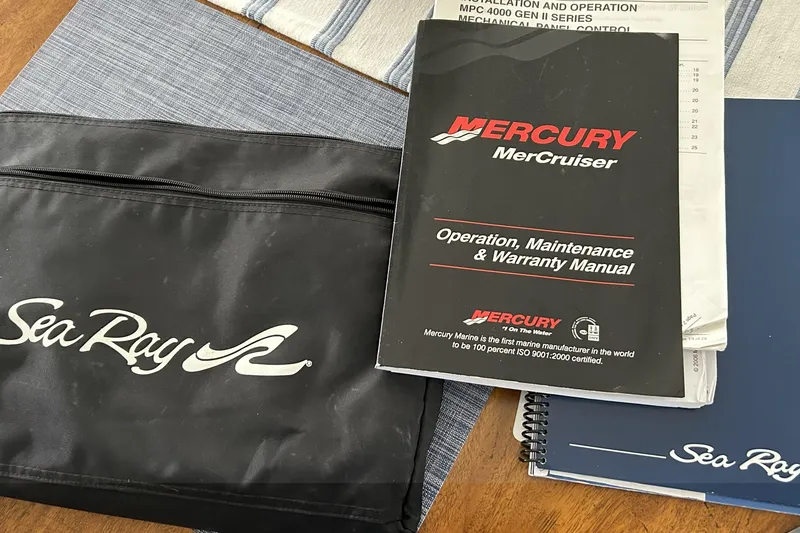 Slide: The Image of Sea Ray 205 Sport 2007 manuals and Mercury MerCruiser operation guide on a table. - 13