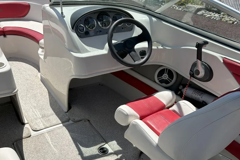 Slide: The Image of 2007 Sea Ray 205 Sport boat interior with red and white seating, steering wheel, and control panel. - 5