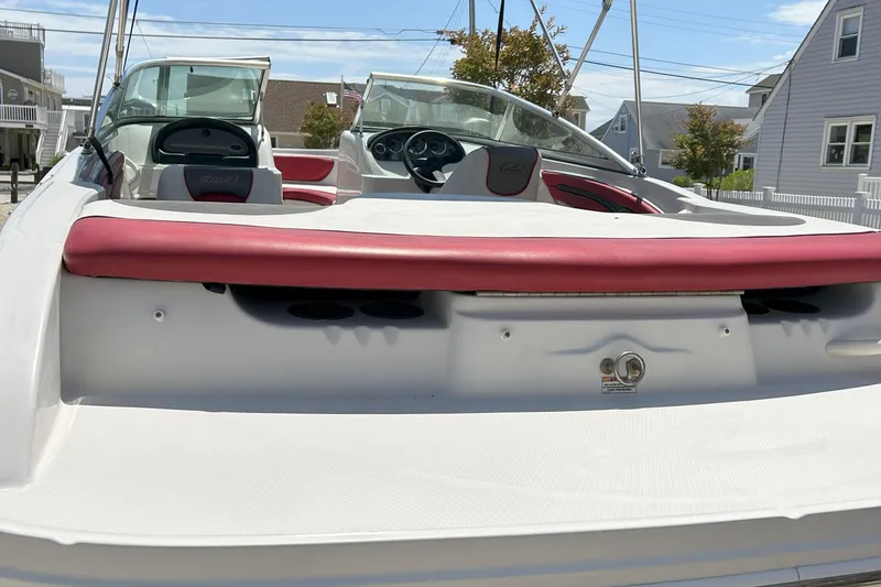 Slide: The Image of 2007 Sea Ray 205 Sport boat with red and white interior, docked outdoors. - 8