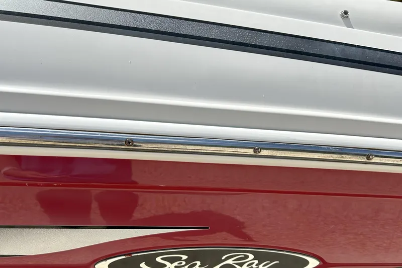 Slide: The Image of 2007 Sea Ray 205 Sport boat, red and white exterior with logo detail. - 9