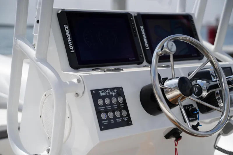 Slide: The Image of 2026 Tide Craft Galveston 19 boat dashboard with steering wheel and Lowrance displays. - 14