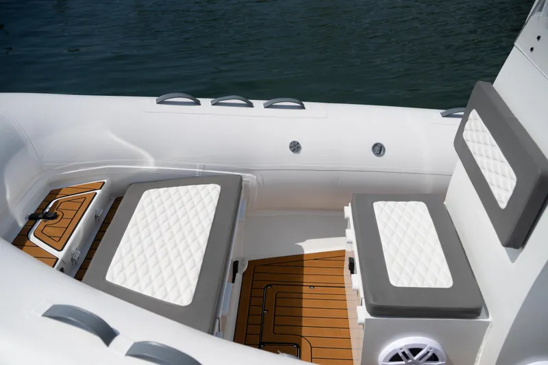 Slide: The Image of 2026 Tide Craft Galveston 19 boat interior with cushioned seating and teak flooring. - 18