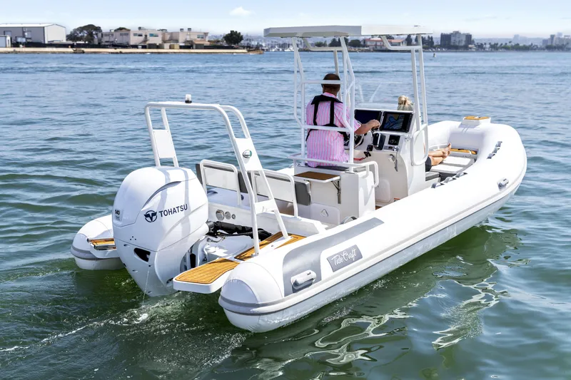 Slide: The Image of 2026 Tide Craft Galveston 19 boat on water, featuring Tohatsu engine, with two passengers. - 2