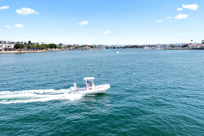 Slide: The Image of 2026 Tide Craft Galveston 19 boat cruising on a sunny day in a scenic harbor. - 3
