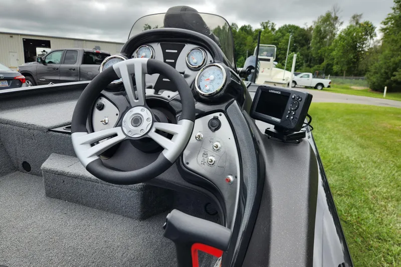 Slide: The Image of 2023 Tracker Pro Team 190 TX boat dashboard with steering wheel and navigation system. - 11