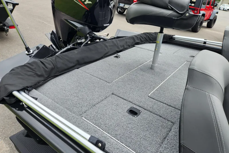 Slide: The Image of 2023 Tracker Pro Team 190 TX boat interior with seating and motor, showcasing fishing deck. - 13